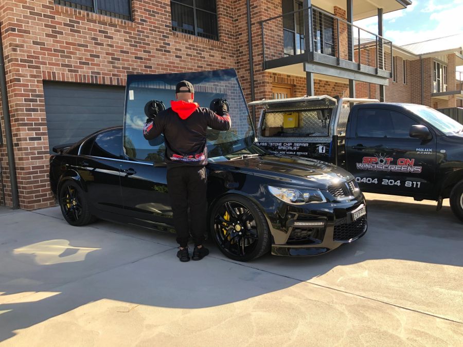 Cameron from Spot On Windscreens fitting a windscreen to an HSV sedan